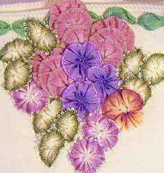 Close up of ribbon worked flowers and leaves